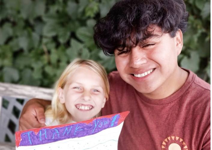 James Ronaldo Meyer, a student who builds homes in Guatemala, smiles with his younger sister