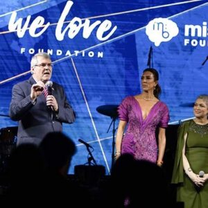 Ed Rain speaks to the audience from the stage at the We Love Foundation Gala