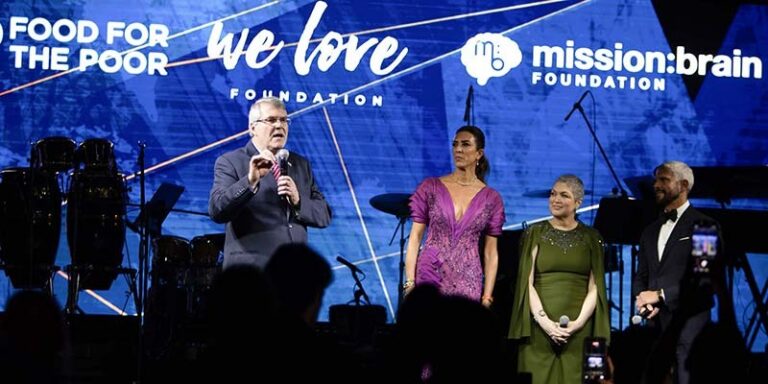 Ed Rain speaks to the audience from the stage at the We Love Foundation Gala