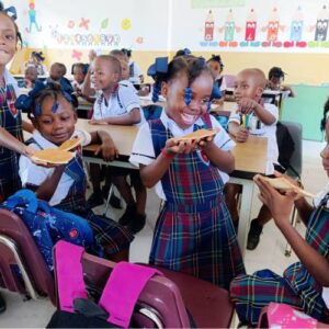 Haitian girls eating breakfast at school thanks to FFTP Shine program for World Food Day